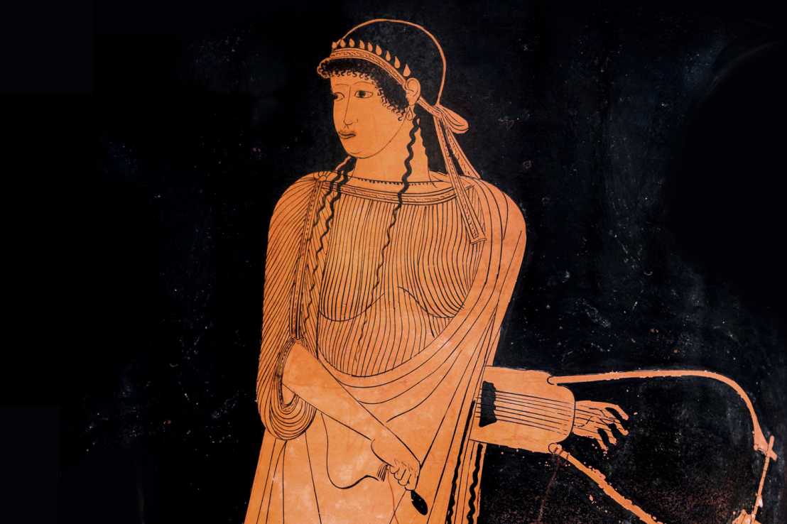 red figure of a Greek woman holding an instrument in front of a black background